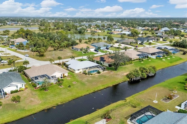 drone / aerial view with a water view and a residential view