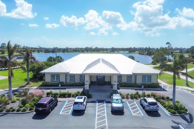 view of property featuring uncovered parking and a water view