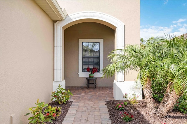 property entrance with stucco siding