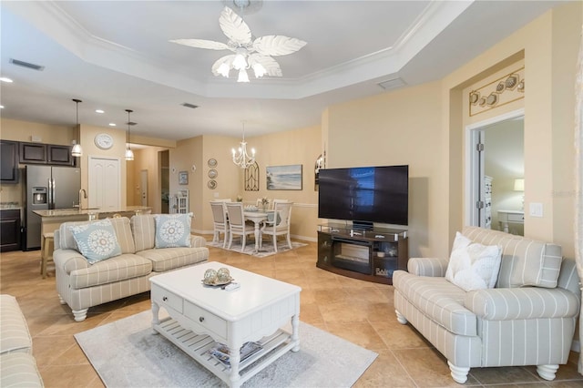 living area with light tile patterned floors, visible vents, and a raised ceiling