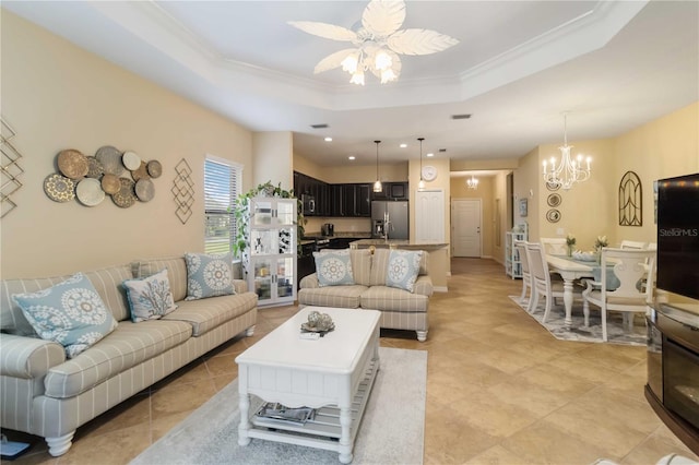 living room featuring ornamental molding, a tray ceiling, and ceiling fan with notable chandelier