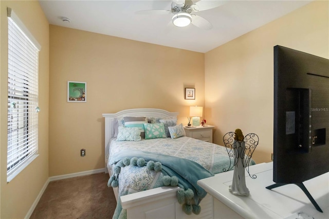 carpeted bedroom with ceiling fan and baseboards