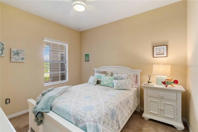 bedroom with a ceiling fan, carpet flooring, and baseboards