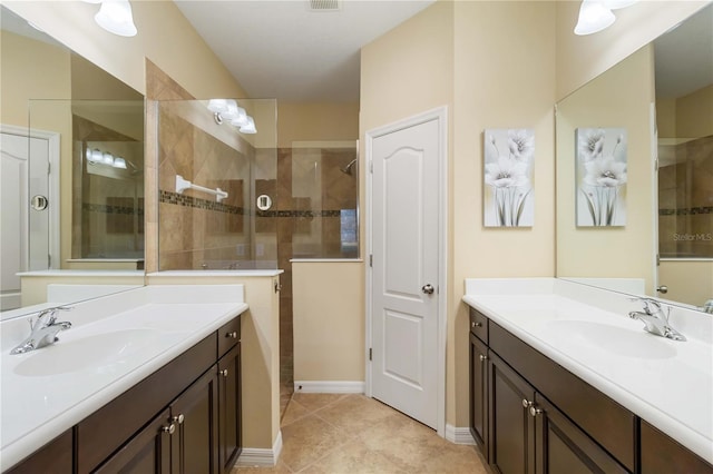 bathroom with two vanities, visible vents, a walk in shower, and a sink