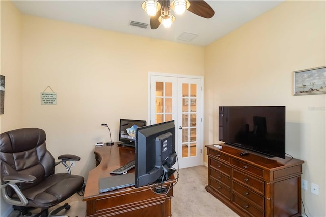 office space with french doors, visible vents, ceiling fan, and light carpet