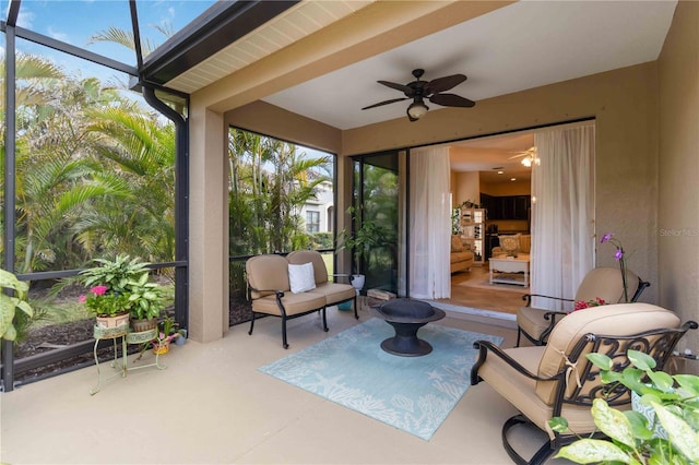 sunroom / solarium featuring ceiling fan