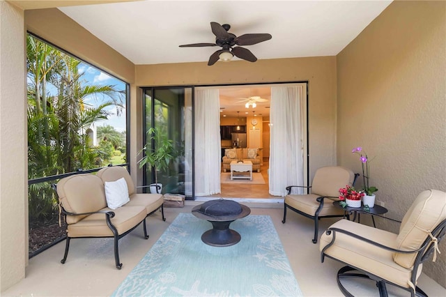 view of patio / terrace with ceiling fan and an outdoor living space