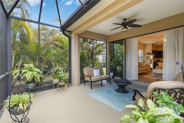 sunroom featuring ceiling fan