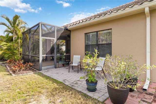 view of patio with glass enclosure