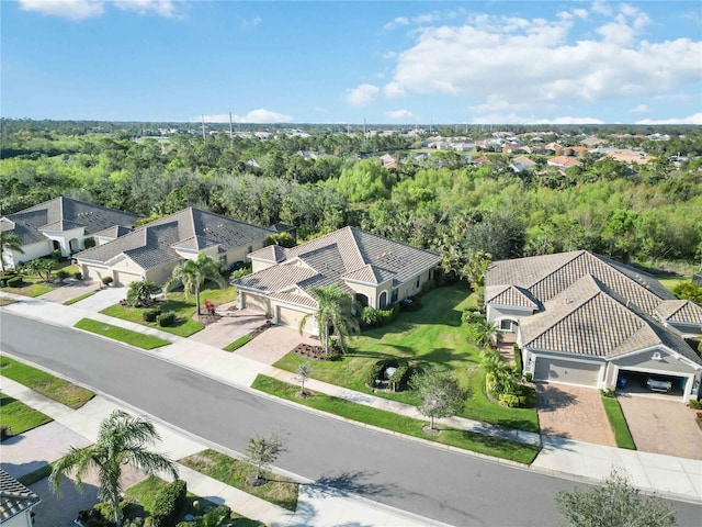 birds eye view of property featuring a view of trees