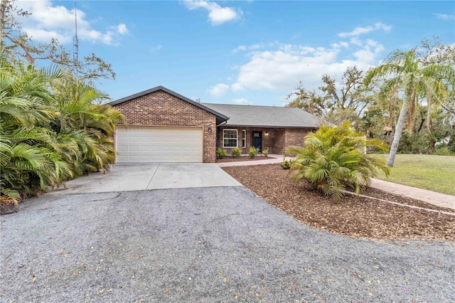 ranch-style house with driveway, a garage, and brick siding