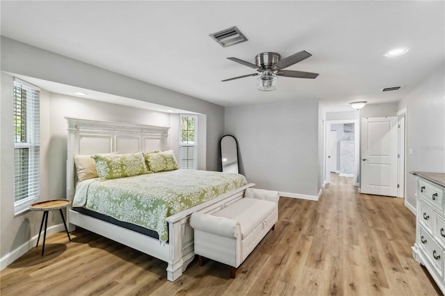 bedroom featuring baseboards, visible vents, and light wood-style floors