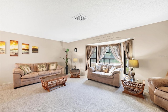 carpeted living room featuring a textured ceiling, visible vents, and baseboards