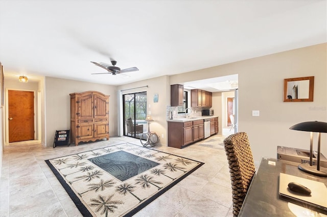 living area with a ceiling fan