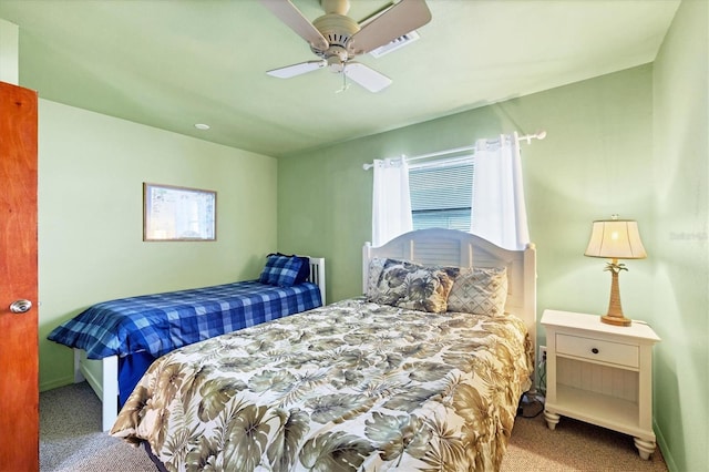 carpeted bedroom featuring baseboards and a ceiling fan