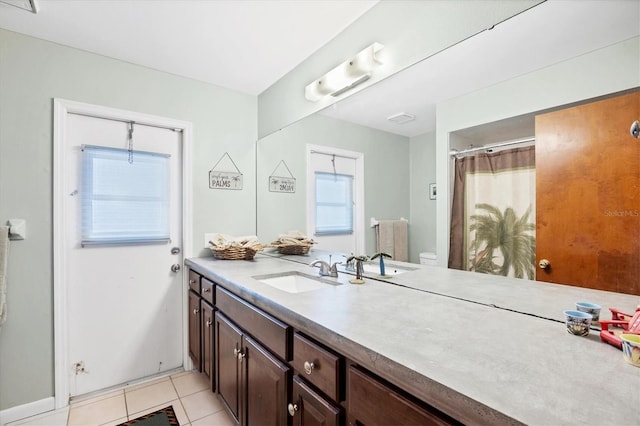 bathroom with curtained shower, toilet, visible vents, vanity, and tile patterned floors