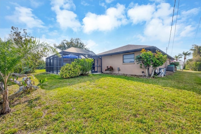 view of yard with a lanai and central AC