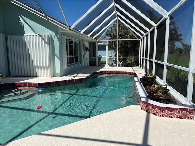 pool with glass enclosure and a patio