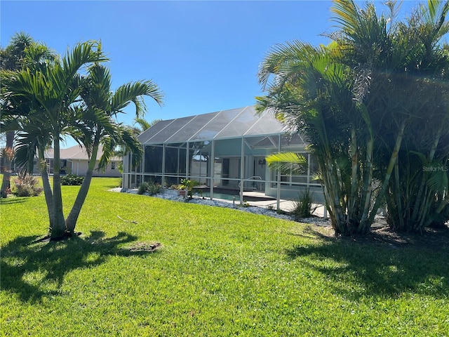 view of yard featuring a lanai and an outdoor pool