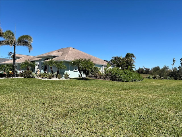 108 Fairway Rd, Rotonda West, FL 33947 - view of home's exterior featuring a yard and stucco siding