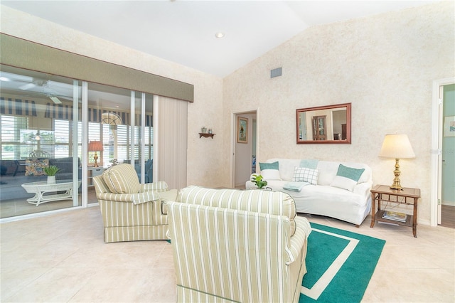 living room featuring light tile patterned floors, high vaulted ceiling, and a ceiling fan