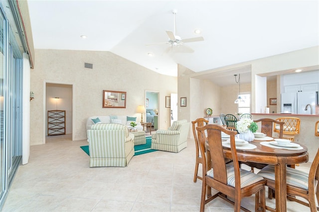 dining space featuring vaulted ceiling, ceiling fan, light tile patterned floors, and visible vents