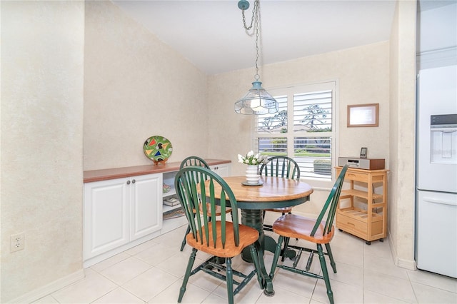 dining space with light tile patterned floors and baseboards