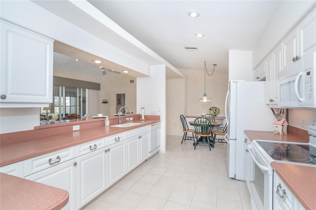 kitchen with white appliances, a sink, white cabinetry, and recessed lighting