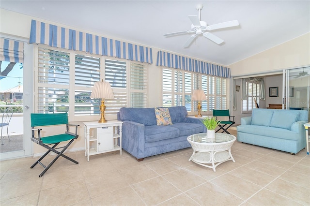 tiled living area featuring lofted ceiling and a ceiling fan