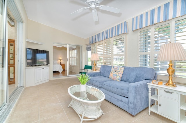 living room with light tile patterned floors, vaulted ceiling, and a ceiling fan