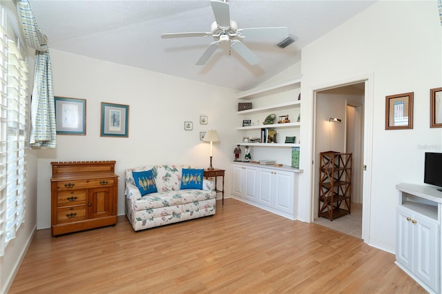 sitting room with lofted ceiling, visible vents, ceiling fan, and light wood finished floors