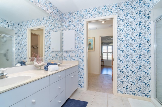 full bathroom with a shower stall, a sink, and tile patterned floors