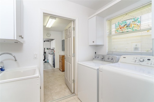 laundry area with washer and clothes dryer, light tile patterned flooring, a sink, and cabinet space