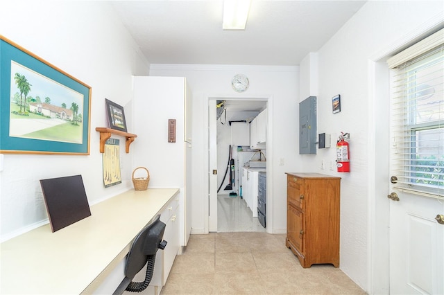 hall with light tile patterned floors and electric panel