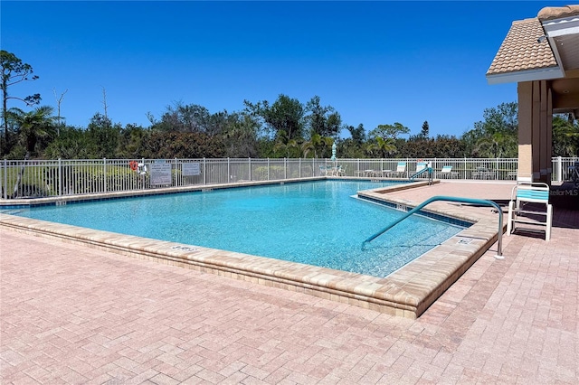 pool featuring a patio area and fence