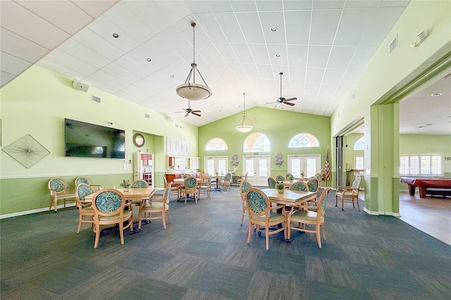 carpeted dining room featuring ceiling fan, high vaulted ceiling, french doors, and visible vents