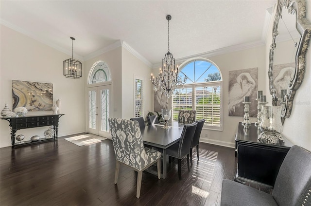 dining space with crown molding, french doors, dark wood-style flooring, and a notable chandelier