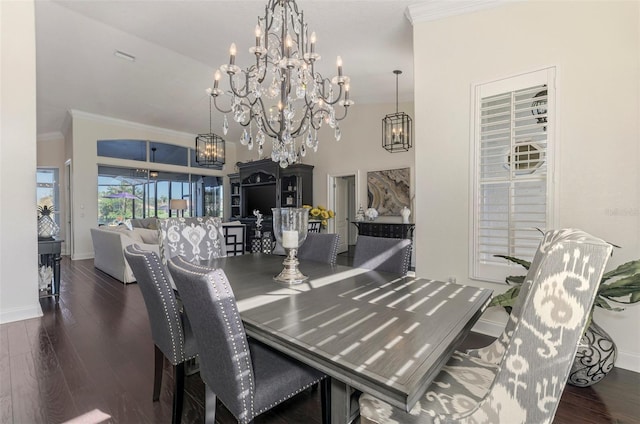 dining room with an inviting chandelier, crown molding, baseboards, and wood finished floors