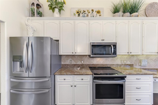 kitchen with appliances with stainless steel finishes, white cabinetry, and backsplash