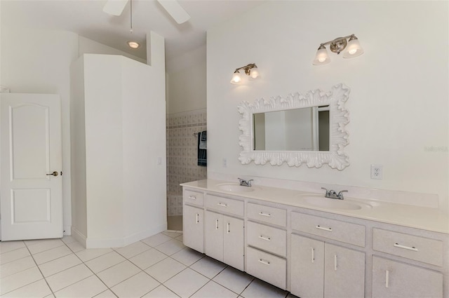 full bath with ceiling fan, double vanity, tile patterned flooring, and a sink