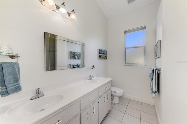 bathroom with tile patterned flooring, a sink, baseboards, and double vanity