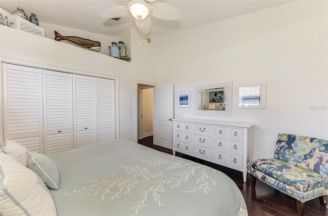 bedroom featuring ceiling fan, high vaulted ceiling, dark wood finished floors, and a closet