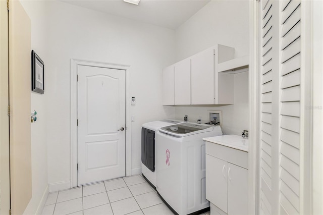 washroom with washer and clothes dryer, light tile patterned flooring, cabinet space, and baseboards