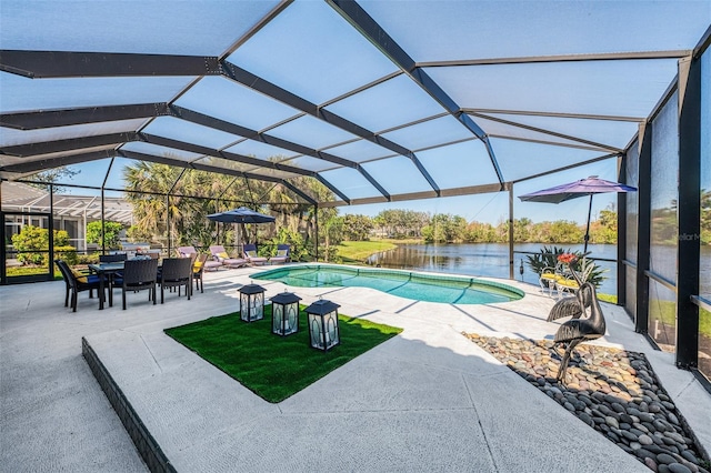 pool featuring a lanai, a water view, and a patio