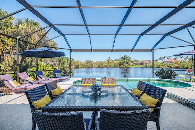 view of patio / terrace with a lanai, a water view, an outdoor pool, and outdoor dining area