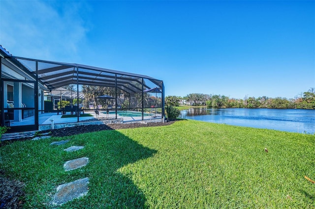 view of yard featuring a patio area, a water view, a lanai, and an outdoor pool