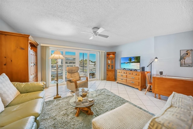 tiled living room featuring a textured ceiling and ceiling fan