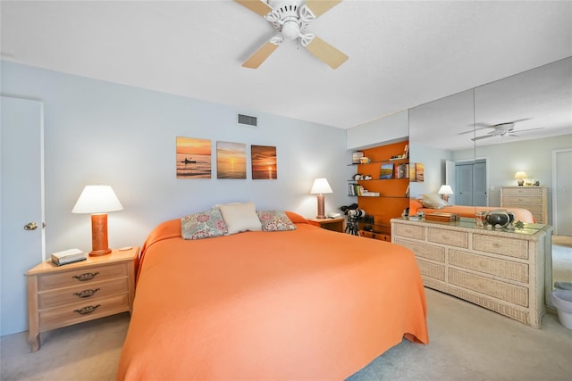 carpeted bedroom with visible vents and ceiling fan