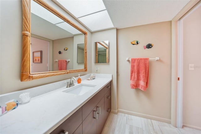 bathroom featuring vanity and baseboards