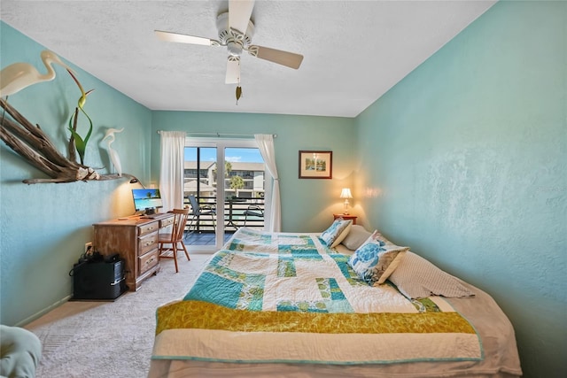 bedroom with a ceiling fan, access to exterior, carpet, and a textured ceiling